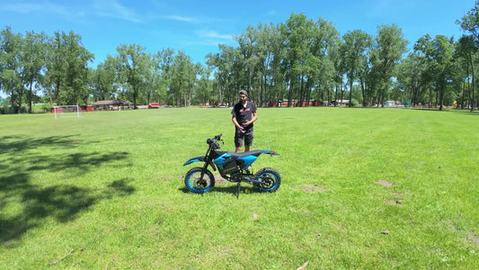 Adult rider beside the compact ZAWES S3 mini electric dirt bike
